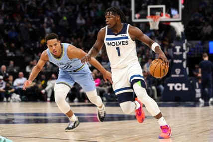Feb 24, 2022; Minneapolis, Minnesota, USA; Minnesota Timberwolves forward Anthony Edwards (1) drives to the basket past Memphis Grizzlies guard Desmond Bane (22)  quarter at Target Center. Mandatory Credit: David Berding-USA TODAY Sports