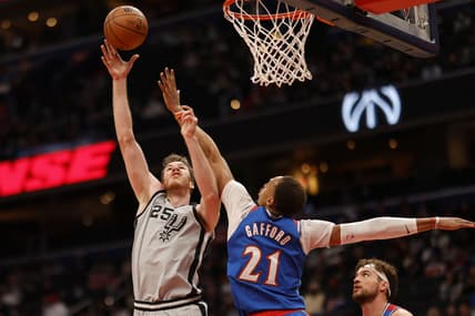 Feb 25, 2022; Washington, District of Columbia, USA; San Antonio Spurs center Jakob Poeltl (25) shoots the ball over Washington Wizards center Daniel Gafford (21) in the first quarter at Capital One Arena. Mandatory Credit: Geoff Burke-USA TODAY Sports