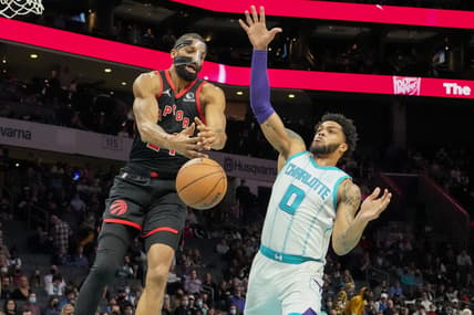 Feb 25, 2022; Charlotte, North Carolina, USA; Toronto Raptors center Khem Birch (24) loses the ball pressured by Charlotte Hornets forward Miles Bridges (0) during the first quarter at the Spectrum Center. Mandatory Credit: Jim Dedmon-USA TODAY Sports