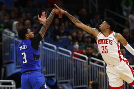 Feb 25, 2022; Orlando, Florida, USA; Orlando Magic forward Chuma Okeke (3) makes a three point basket over Houston Rockets center Christian Wood (35) during the second quarter at Amway Center. Mandatory Credit: Kim Klement-USA TODAY Sports