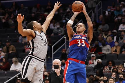 Feb 25, 2022; Washington, District of Columbia, USA; Washington Wizards forward Kyle Kuzma (33) shoots the ball over San Antonio Spurs forward Keldon Johnson (3) in the third quarter at Capital One Arena. Mandatory Credit: Geoff Burke-USA TODAY Sports