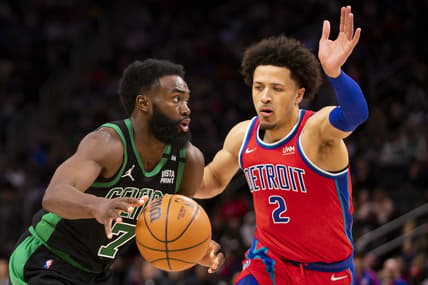 Feb 26, 2022; Detroit, Michigan, USA; Boston Celtics guard Jaylen Brown (7) drives to the basket against Detroit Pistons guard Cade Cunningham (2) during the fourth quarter at Little Caesars Arena. Mandatory Credit: Raj Mehta-USA TODAY Sports