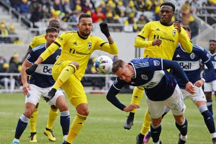 Feb 26, 2022; Columbus, OH, USA; Columbus Crew midfielder Artur (8) and Vancouver Whitecaps defender Jake Nerwinski (28) make a play for the ball during the first half at Lower.com Field. Mandatory Credit: Trevor Ruszkowski-USA TODAY Sports