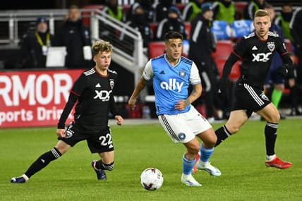 Feb 26, 2022; Washington, District of Columbia, USA; Charlotte FC forward Christian Ortiz (10) and D.C. United forward Griffin Yow (22) battle for the ball in the first half at Audi Field. Mandatory Credit: Brad Mills-USA TODAY Sports