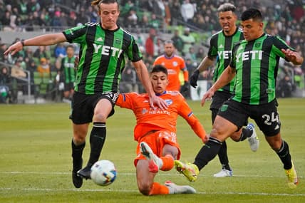 Feb 26, 2022; Austin, Texas, USA; FC Cincinnati forward Nicholas Markanich (33) reaches for the ball between Austin FC midfielder Kipp Keller (left) and Austin FC defender Zan Kolmanic (right) during the first half at Q2 Stadium. Mandatory Credit: Scott Wachter-USA TODAY Sports