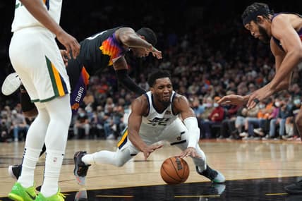 Feb 27, 2022; Phoenix, Arizona, USA; Utah Jazz guard Donovan Mitchell (45) falls against the Phoenix Suns during the first half at Footprint Center. Mandatory Credit: Joe Camporeale-USA TODAY Sports