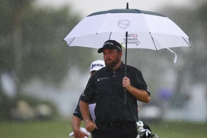 Feb 27, 2022; Palm Beach Gardens, Florida, USA; Shane Lowry holds an umbrella on the 18th green while it rains during the final round of The Honda Classic golf tournament. Mandatory Credit: Sam Navarro-USA TODAY Sports