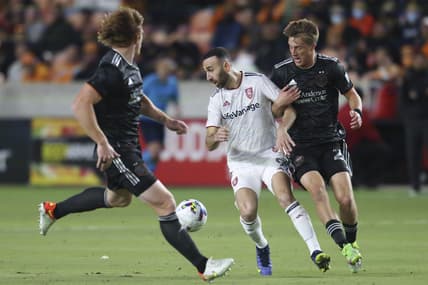 Feb 27, 2022; Houston, Texas, USA;  Real Salt Lake midfielder Justin Meram (9) and Houston Dynamo FC defender Daniel Steres (2) fight over the ball in the first half at PNC Stadium. Mandatory Credit: Thomas Shea-USA TODAY Sports