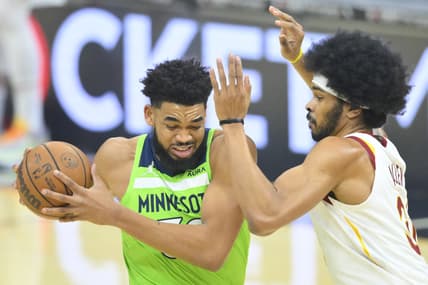 Feb 28, 2022; Cleveland, Ohio, USA; Minnesota Timberwolves center Karl-Anthony Towns (32) drives to the basket beside Cleveland Cavaliers center Jarrett Allen (31) in the first quarter at Rocket Mortgage FieldHouse. Mandatory Credit: David Richard-USA TODAY Sports