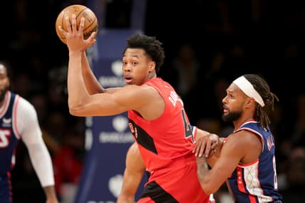 Feb 28, 2022; Brooklyn, New York, USA; Toronto Raptors forward Scottie Barnes (4) controls the ball against Brooklyn Nets guard Patty Mills (8) during the third quarter at Barclays Center. Mandatory Credit: Brad Penner-USA TODAY Sports