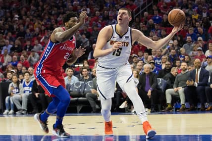 Feb 8, 2019; Philadelphia, PA, USA; Denver Nuggets center Nikola Jokic (15) shoots the ball past Philadelphia 76ers center Joel Embiid (21) during the first quarter at Wells Fargo Center. Mandatory Credit: Bill Streicher-USA TODAY Sports