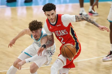 May 9, 2021; Charlotte, North Carolina, USA; Charlotte Hornets guard LaMelo Ball, left, battles New Orleans Pelicans guard Lonzo Ball (2) for a loose ball in the second half at Spectrum Center. The New Orleans Pelicans won 112-110. Mandatory Credit: Nell Redmond-USA TODAY Sports