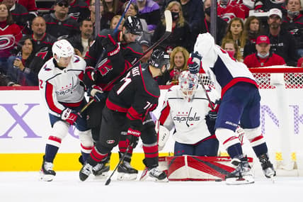 Nov 28, 2021; Raleigh, North Carolina, USA;  Washington Capitals goaltender Ilya Samsonov (30) stops Carolina Hurricanes right wing Jesper Fast (71) and center Jordan Staal (11) during the third period at PNC Arena. Mandatory Credit: James Guillory-USA TODAY Sports