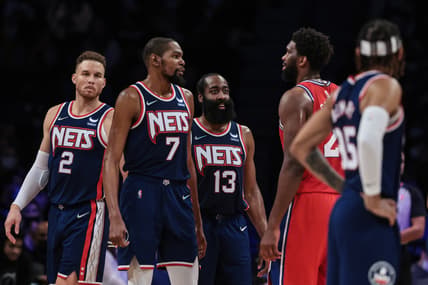 Dec 30, 2021; Brooklyn, New York, USA; Brooklyn Nets forward Kevin Durant (7) and guard James Harden (13) talks with Philadelphia 76ers center Joel Embiid (21) during the second half at Barclays Center. Mandatory Credit: Vincent Carchietta-USA TODAY Sports