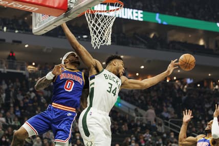 Jan 13, 2022; Milwaukee, Wisconsin, USA;  Milwaukee Bucks forward Giannis Antetokounmpo (34) reaches for the rebound in front of Golden State Warriors guard Gary Payton II (0) during the first quarter at Fiserv Forum. Mandatory Credit: Jeff Hanisch-USA TODAY Sports