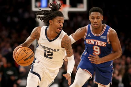 Feb 2, 2022; New York, New York, USA; Memphis Grizzlies guard Ja Morant (12) drives to the basket against New York Knicks guard RJ Barrett (9) during the third quarter at Madison Square Garden. Mandatory Credit: Brad Penner-USA TODAY Sports