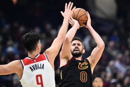 Feb 26, 2022; Cleveland, Ohio, USA; Cleveland Cavaliers forward Kevin Love (0) shoots over the defense of Washington Wizards forward Deni Avdija (9) during the first half at Rocket Mortgage FieldHouse. Mandatory Credit: Ken Blaze-USA TODAY Sports