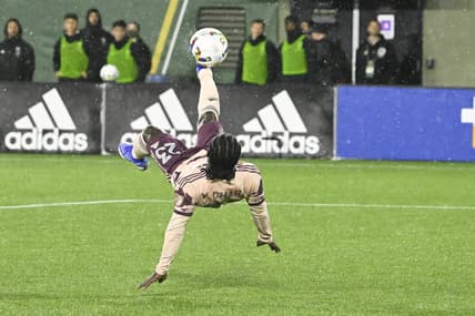 Feb 26, 2022; Portland, Oregon, USA; Portland Timbers forward Yimmi Chara (23) scores a goal off a bicycle kick during the second half against the New England Revolution at Providence Park. The game ended in a tie 2-2. Mandatory Credit: Troy Wayrynen-USA TODAY Sports