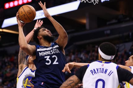 Mar 1, 2022; Minneapolis, Minnesota, USA; Minnesota Timberwolves center Karl-Anthony Towns (32) shoots the ball as Golden State Warriors guard Gary Payton II (0) guards him during the fourth quarter at Target Center. Mandatory Credit: Harrison Barden-USA TODAY Sports