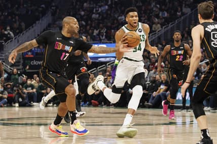 Mar 2, 2022; Milwaukee, Wisconsin, USA;  Miami Heat forward P.J. Tucker (17) hits the ball away from Milwaukee Bucks forward Giannis Antetokounmpo (34) during the first quarter at Fiserv Forum. Mandatory Credit: Jeff Hanisch-USA TODAY Sports