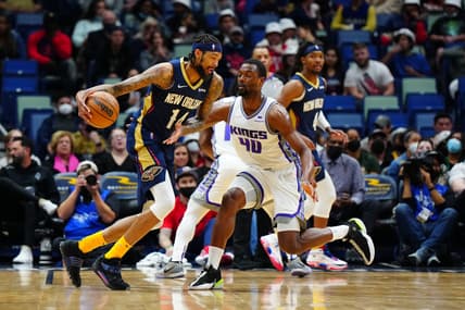 Mar 2, 2022; New Orleans, Louisiana, USA; New Orleans Pelicans forward Brandon Ingram (14) dribbles the ball against Sacramento Kings forward Harrison Barnes (40) during the first quarter at Smoothie King Center. Mandatory Credit: Andrew Wevers-USA TODAY Sports