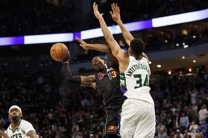 Mar 2, 2022; Milwaukee, Wisconsin, USA;  Miami Heat center Bam Adebayo (13) passes the ball under pressure from Milwaukee Bucks forward Giannis Antetokounmpo (34) during the fourth quarter at Fiserv Forum. Mandatory Credit: Jeff Hanisch-USA TODAY Sports