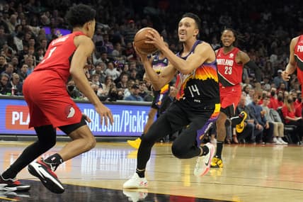 Mar 2, 2022; Phoenix, Arizona, USA; Phoenix Suns guard Landry Shamet (14) drives past Portland Trail Blazers guard Anfernee Simons (1) in the first half at Footprint Center. Mandatory Credit: Rick Scuteri-USA TODAY Sports
