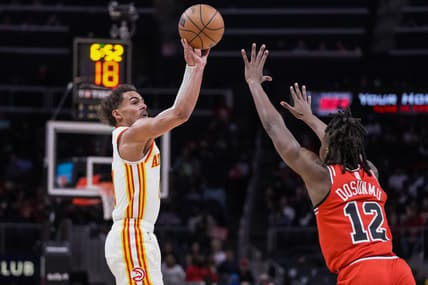 Mar 3, 2022; Atlanta, Georgia, USA; Atlanta Hawks guard Trae Young (11) shoots over Chicago Bulls guard Ayo Dosunmu (12) during the first half at State Farm Arena. Mandatory Credit: Dale Zanine-USA TODAY Sports
