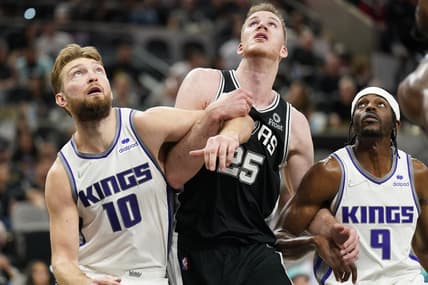 Mar 3, 2022; San Antonio, Texas, USA; San Antonio Spurs center Jakob Poeltl (25) Sacramento Kings forwards Domantas Sabonis (10) and Justin Holiday (9) battle for the rebound during the first half at AT&T Center. Mandatory Credit: Scott Wachter-USA TODAY Sports
