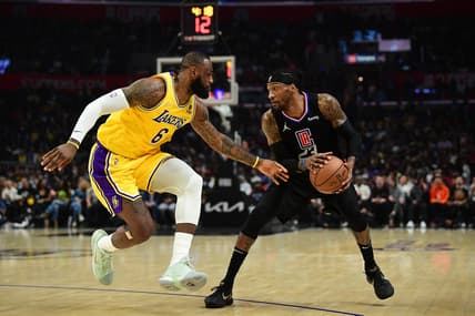 Mar 3, 2022; Los Angeles, California, USA; Los Angeles Clippers forward Robert Covington (23) controls the ball against Los Angeles Lakers forward LeBron James (6) during the first half at Crypto.com Arena. Mandatory Credit: Gary A. Vasquez-USA TODAY Sports