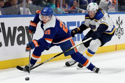 Mar 5, 2022; Elmont, New York, USA; New York Islanders defenseman Sebastian Aho (25) controls the puck against St. Louis Blues center Oskar Sundqvist (70) during the first period at UBS Arena. Mandatory Credit: Brad Penner-USA TODAY Sports