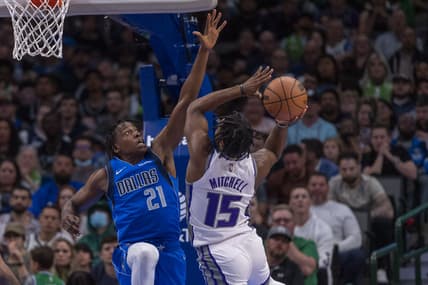 Mar 5, 2022; Dallas, Texas, USA; Dallas Mavericks guard Frank Ntilikina (21) defends against Sacramento Kings guard Davion Mitchell (15) during the second quarter at the American Airlines Center. Mandatory Credit: Jerome Miron-USA TODAY Sports