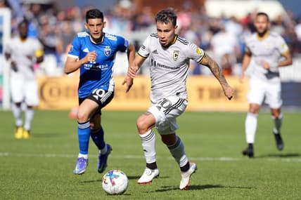 Mar 5, 2022; San Jose, California, USA; Columbus Crew midfielder Lucas Zelarayan (10) dribbles against San Jose Earthquakes forward Cristian Espinoza (10) during the first half at PayPal Park. Mandatory Credit: Darren Yamashita-USA TODAY Sports