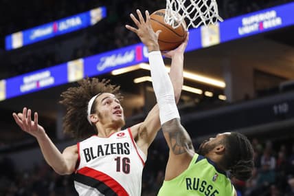 Mar 5, 2022; Minneapolis, Minnesota, USA; Portland Trail Blazers forward CJ Elleby (16) goes to the basket as Minnesota Timberwolves guard D'Angelo Russell (0) defends him in the first quarter at Target Center. Mandatory Credit: Bruce Kluckhohn-USA TODAY Sports