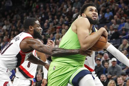Mar 5, 2022; Minneapolis, Minnesota, USA; Minnesota Timberwolves center Karl-Anthony Towns (32) pulls away from Portland Trail Blazers guard Keljin Blevins (21) and goes to the basket in the fourth quarter at Target Center. Mandatory Credit: Bruce Kluckhohn-USA TODAY Sports