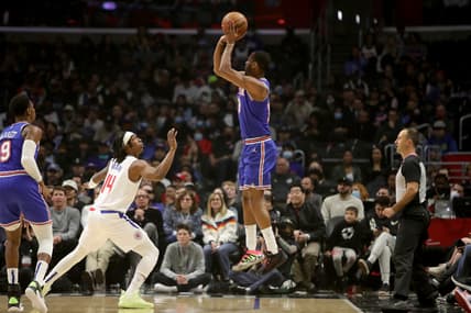 Mar 6, 2022; Los Angeles, California, USA;  New York Knicks guard Alec Burks (18) shoots a ball over Los Angeles Clippers guard Terance Mann (14) during the first quarter at Crypto.com Arena. Mandatory Credit: Kiyoshi Mio-USA TODAY Sports