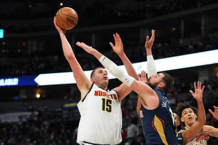 Mar 6, 2022; Denver, Colorado, USA; Denver Nuggets center Nikola Jokic (15) shoots over New Orleans Pelicans center Jonas Valanciunas (17) in the fourth quarter at Ball Arena. Mandatory Credit: Ron Chenoy-USA TODAY Sports
