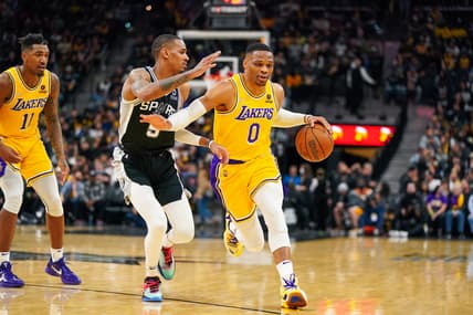 Mar 7, 2022; San Antonio, Texas, USA;  Los Angeles Lakers guard Russell Westbrook (0) dribbles past San Antonio Spurs guard Dejounte Murray (5) in the second half at the AT&T Center. Mandatory Credit: Daniel Dunn-USA TODAY Sports