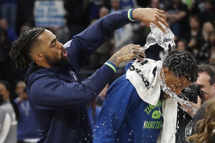 Mar 9, 2022; Minneapolis, Minnesota, USA; Minnesota Timberwolves guard D'Angelo Russell (0) pours water over guard Malik Beasley (5) who set a team record with 11 three point baskets against the Oklahoma City Thunder at Target Center. Mandatory Credit: Bruce Kluckhohn-USA TODAY Sports