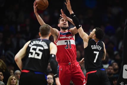 Mar 9, 2022; Los Angeles, California, USA; Washington Wizards guard Tomas Satoransky (31) shoots against Los Angeles Clippers guard Amir Coffey (7) and center Isaiah Hartenstein (55) during the first half at Crypto.com Arena. Mandatory Credit: Gary A. Vasquez-USA TODAY Sports