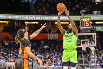 Mar 11, 2022; Orlando, Florida, USA; Minnesota Timberwolves guard Patrick Beverley (22) shoots a three point basket against Orlando Magic guard Cole Anthony (50) during the first quarter at Amway Center. Mandatory Credit: Mike Watters-USA TODAY Sports