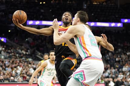 Mar 11, 2022; San Antonio, Texas, USA; Utah Jazz guard Donovan Mitchell drives to the basket while defended by shoots over San Antonio Spurs forward Zach Collins (23) during the first half at AT&T Center. Mandatory Credit: Scott Wachter-USA TODAY Sports