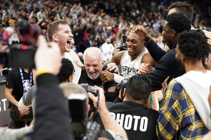 Mar 11, 2022; San Antonio, Texas, USA; San Antonio Spurs head coach Gregg Popovich is congratulated by players after becoming the winningest coach in NBA history after the game against the Utah Jazz at AT&T Center. Mandatory Credit: Scott Wachter-USA TODAY Sports