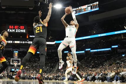 Mar 11, 2022; San Antonio, Texas, USA; San Antonio Spurs guard Dejounte Murray (5) shoots over Utah Jazz center Hassan Whiteside (21) during the second half at AT&T Center. Mandatory Credit: Scott Wachter-USA TODAY Sports