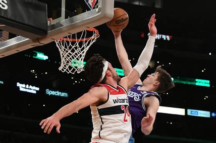 Mar 11, 2022; Los Angeles, California, USA; Los Angeles Lakers guard Austin Reaves (15) shoots against Washington Wizards forward Corey Kispert (24) in the fourth quarter at Crypto.com Arena. Mandatory Credit: Richard Mackson-USA TODAY Sports