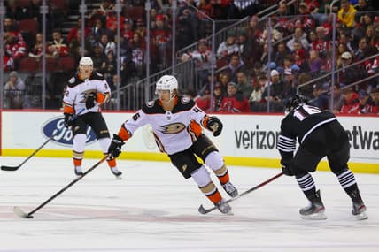 Mar 12, 2022; Newark, New Jersey, USA; Anaheim Ducks center Trevor Zegras (46) skates with the puck while being defended by New Jersey Devils left wing Jimmy Vesey (16) during the first period at Prudential Center. Mandatory Credit: Ed Mulholland-USA TODAY Sports
