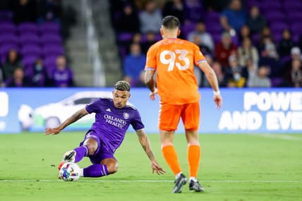 Mar 12, 2022; Orlando, Florida, USA;  Orlando City midfielder J  nior Urso (11) keeps the bay away from FC Cincinnati midfielder J  nior Moreno (93) in the first half at Orlando City Stadium. Mandatory Credit: Nathan Ray Seebeck-USA TODAY Sports