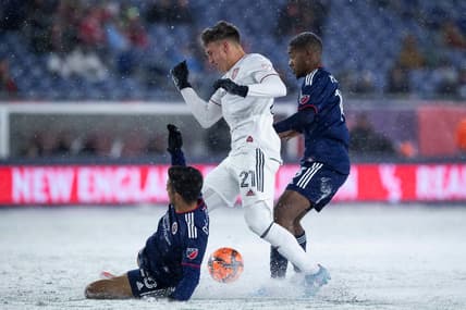 Mar 12, 2022; Foxborough, Massachusetts, USA; New England Revolution defender AJ DeLaGarza (28) slide tackles Real Salt Lake forward Tate Schmitt (21) at Gillette Stadium. Mandatory Credit: Paul Rutherford-USA TODAY Sports