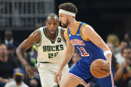 Mar 12, 2022; San Francisco, California, USA; Golden State Warriors guard Klay Thompson (11) dribbles against Milwaukee Bucks forward Khris Middleton (22) during the first quarter at Chase Center. Mandatory Credit: Darren Yamashita-USA TODAY Sports