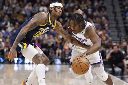Mar 12, 2022; Salt Lake City, Utah, USA; Sacramento Kings guard Davion Mitchell (15) drives against Utah Jazz guard Jordan Clarkson (00) in the second quarter at Vivint Arena. Mandatory Credit: Jeffrey Swinger-USA TODAY Sports